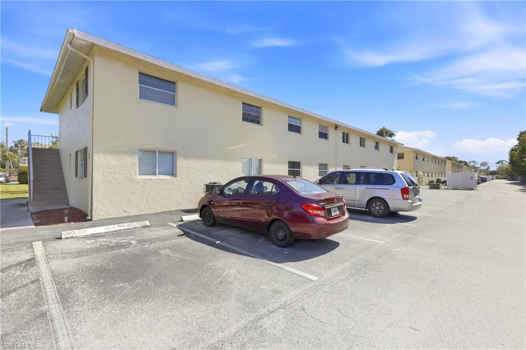 3325 Airport Road North, Unit S8 Naples, FL 34105 - Photo 21 of 33 a car parked in front of a white house