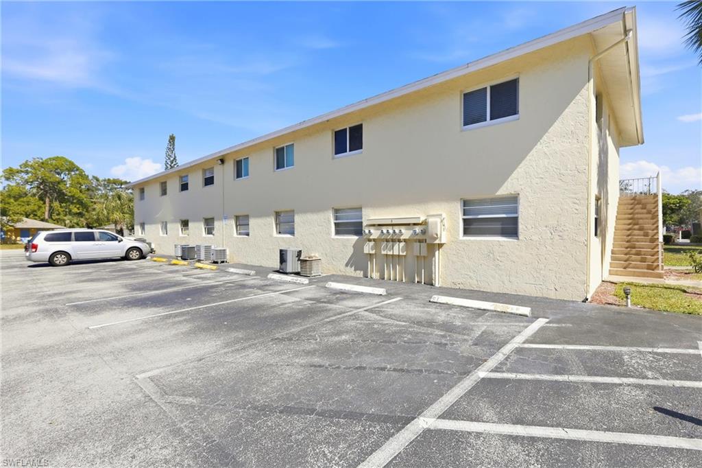 3325 Airport Road North, Unit S8 Naples, FL 34105 - Photo 22 of 33 a view of a building with car parked