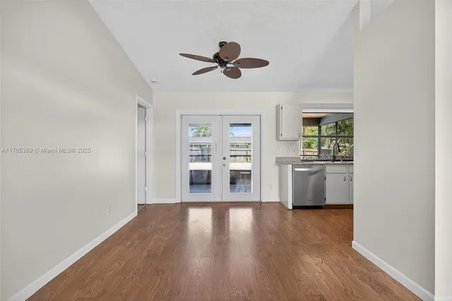 a view of a living room with hardwood floor and a window