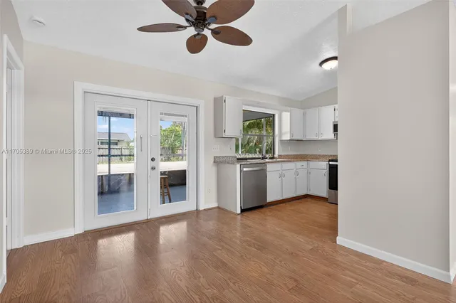 a kitchen with a white cabinets and window