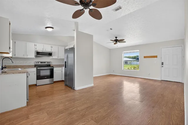 a view of kitchen with microwave and stove