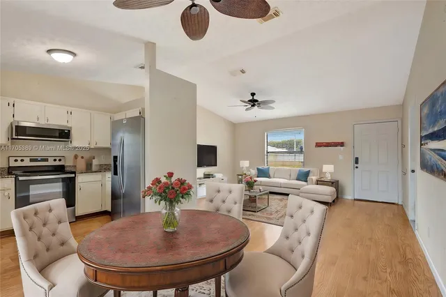 a living room with furniture kitchen view and a fireplace