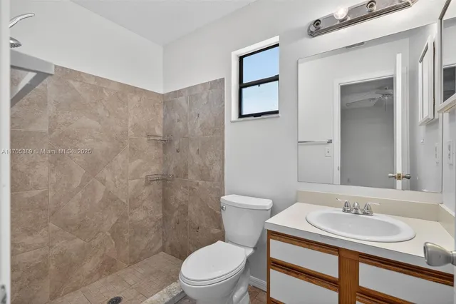 a bathroom with a toilet a sink and mirror