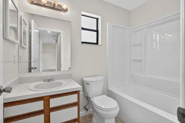 a bathroom with a sink toilet a mirror and shower