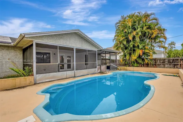 a view of a house with backyard and a slide