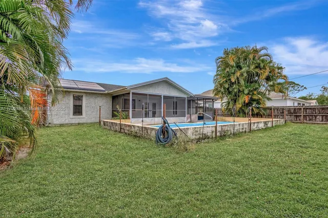 a front view of a house with a garden and yard