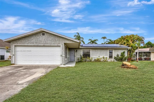 a view of a house with a backyard