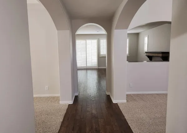 wooden floor in a hall with a window