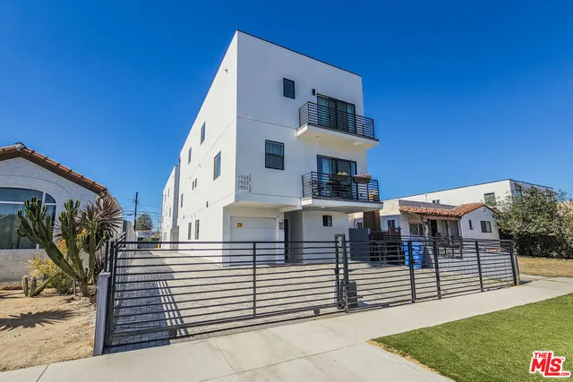a view of a white building with many windows