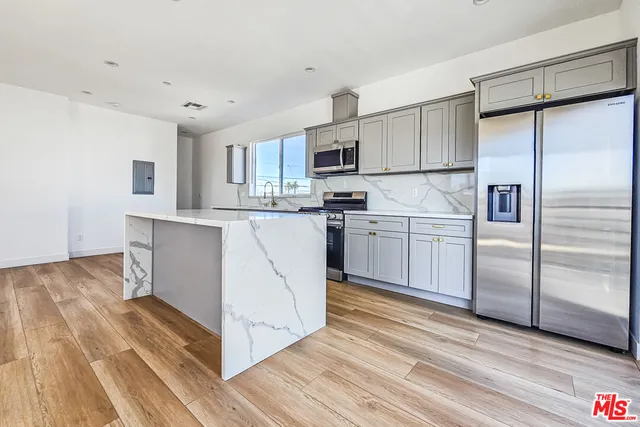 a kitchen with a sink appliances and cabinets