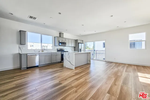 a view of kitchen with sink and wooden floor