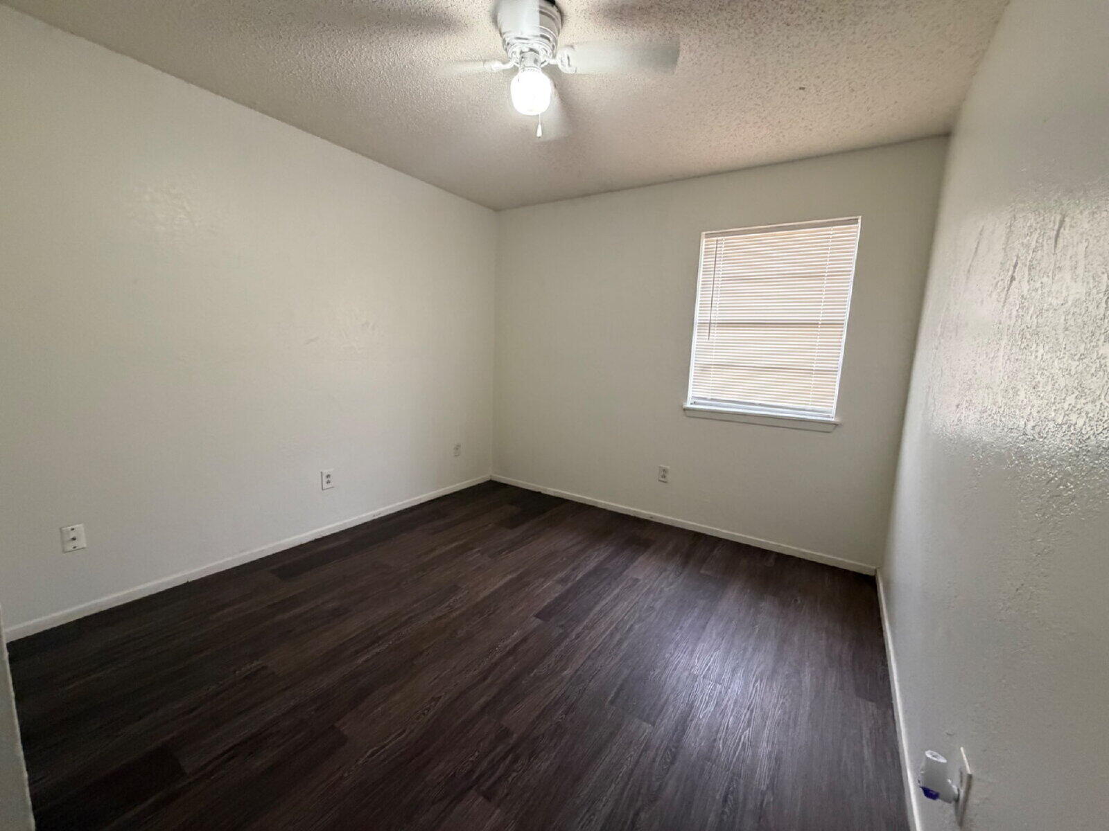 6306 28th Street Lubbock, TX 79407 - Photo 9 of 9 an empty room with wooden floor and windows