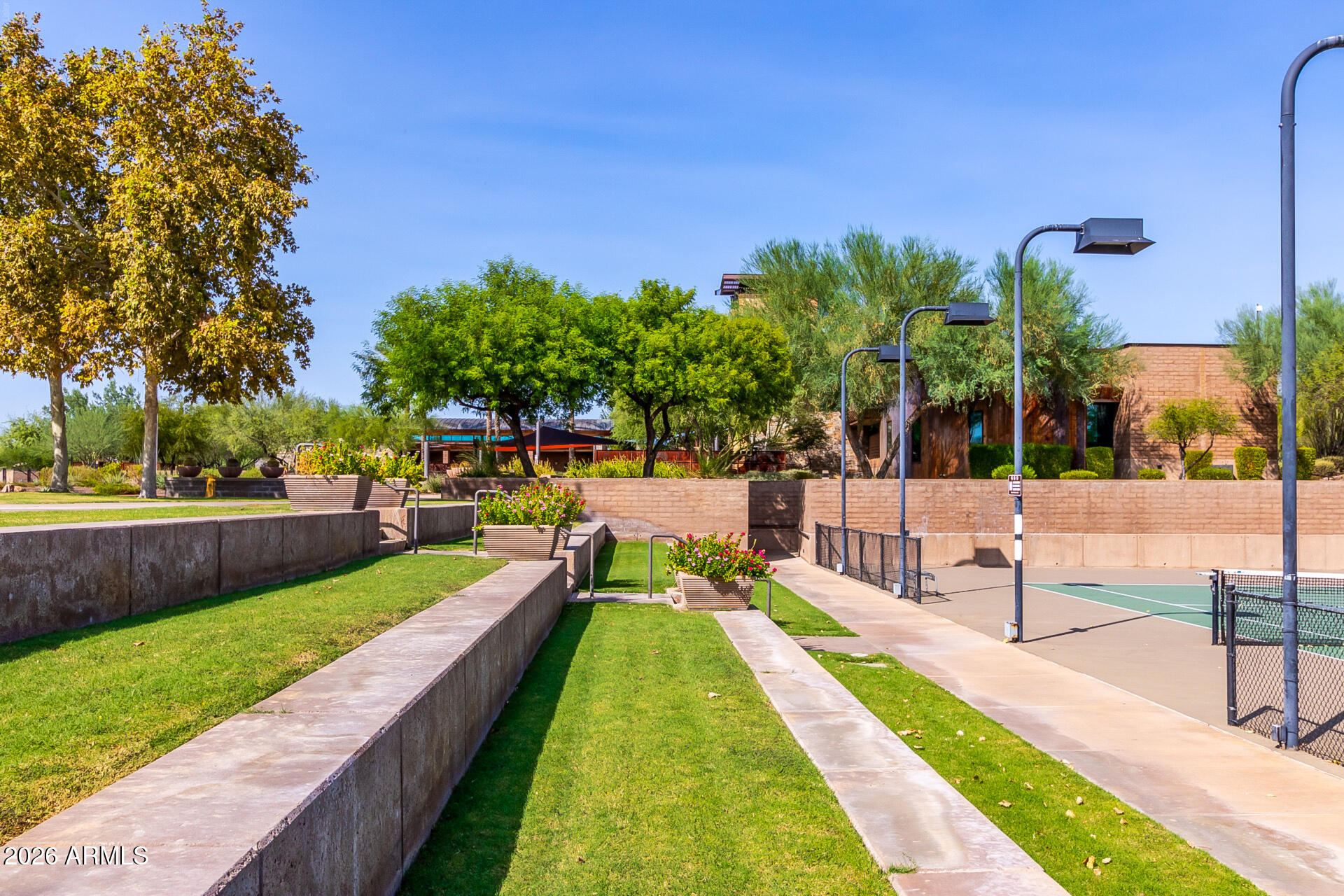 13058 West Lowden Road Peoria, AZ 85383 - Photo 114 of 122 a view of swimming pool with seating area and trees in the background