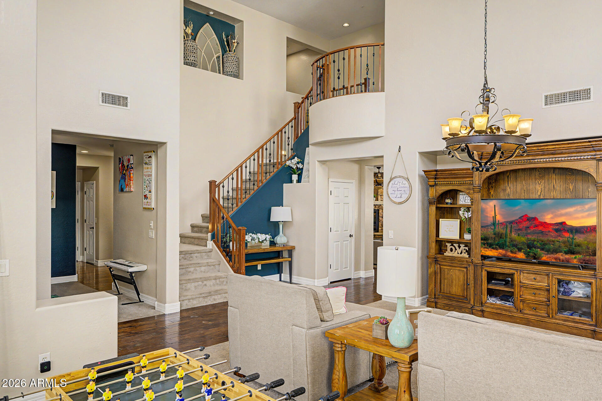 13058 West Lowden Road Peoria, AZ 85383 - Photo 15 of 122 a living room with fireplace furniture and a chandelier
