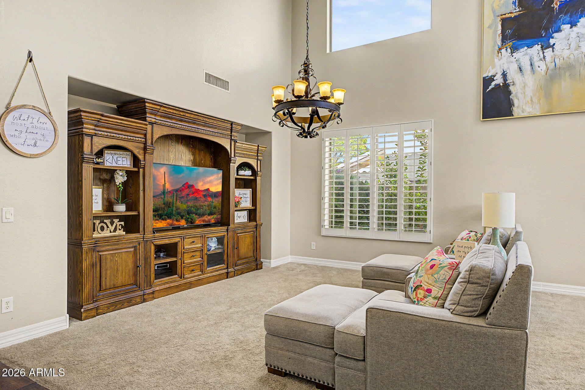 13058 West Lowden Road Peoria, AZ 85383 - Photo 16 of 122 a living room with furniture a fireplace and a chandelier