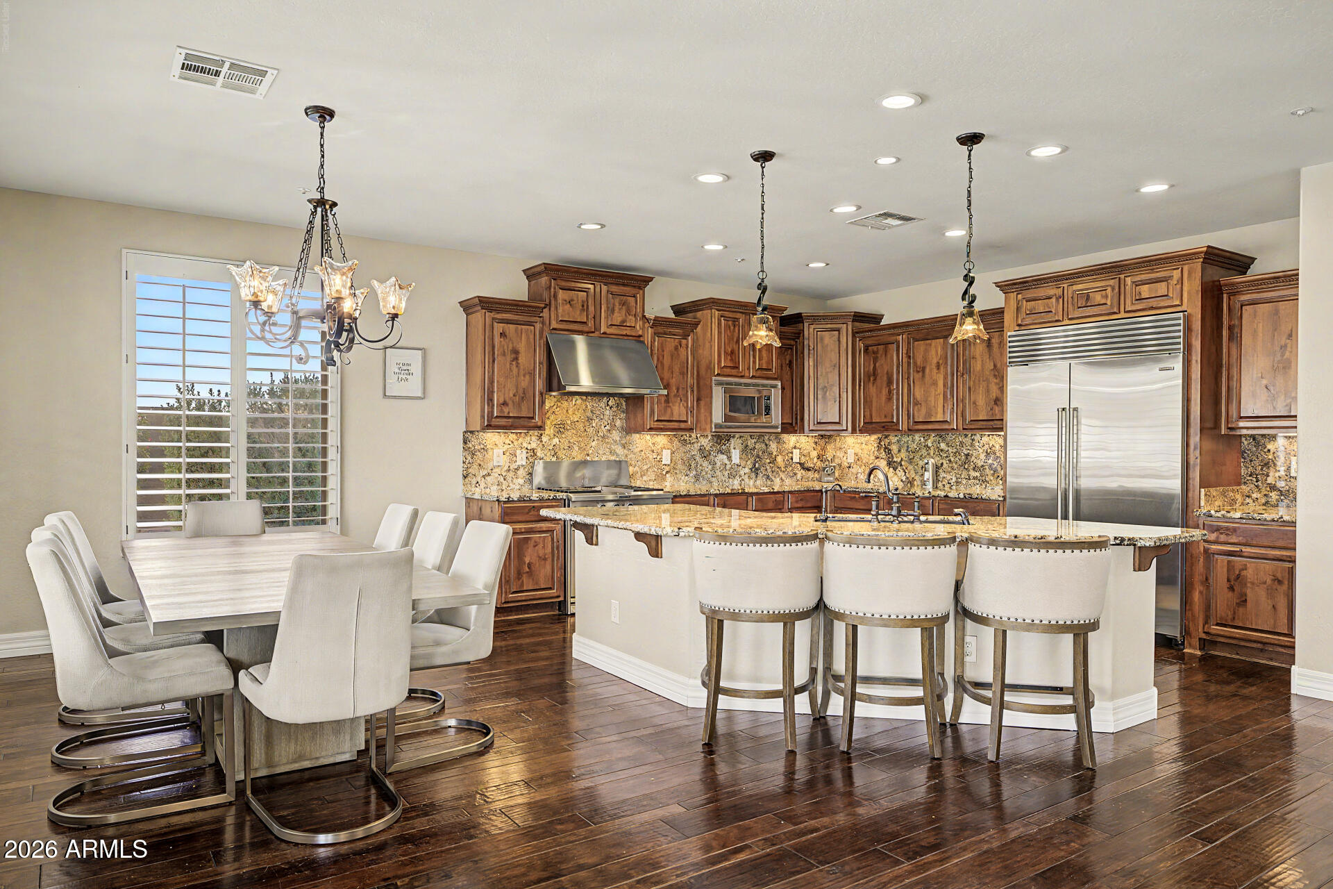 13058 West Lowden Road Peoria, AZ 85383 - Photo 29 of 122 a dining room filled with furniture and wooden floor