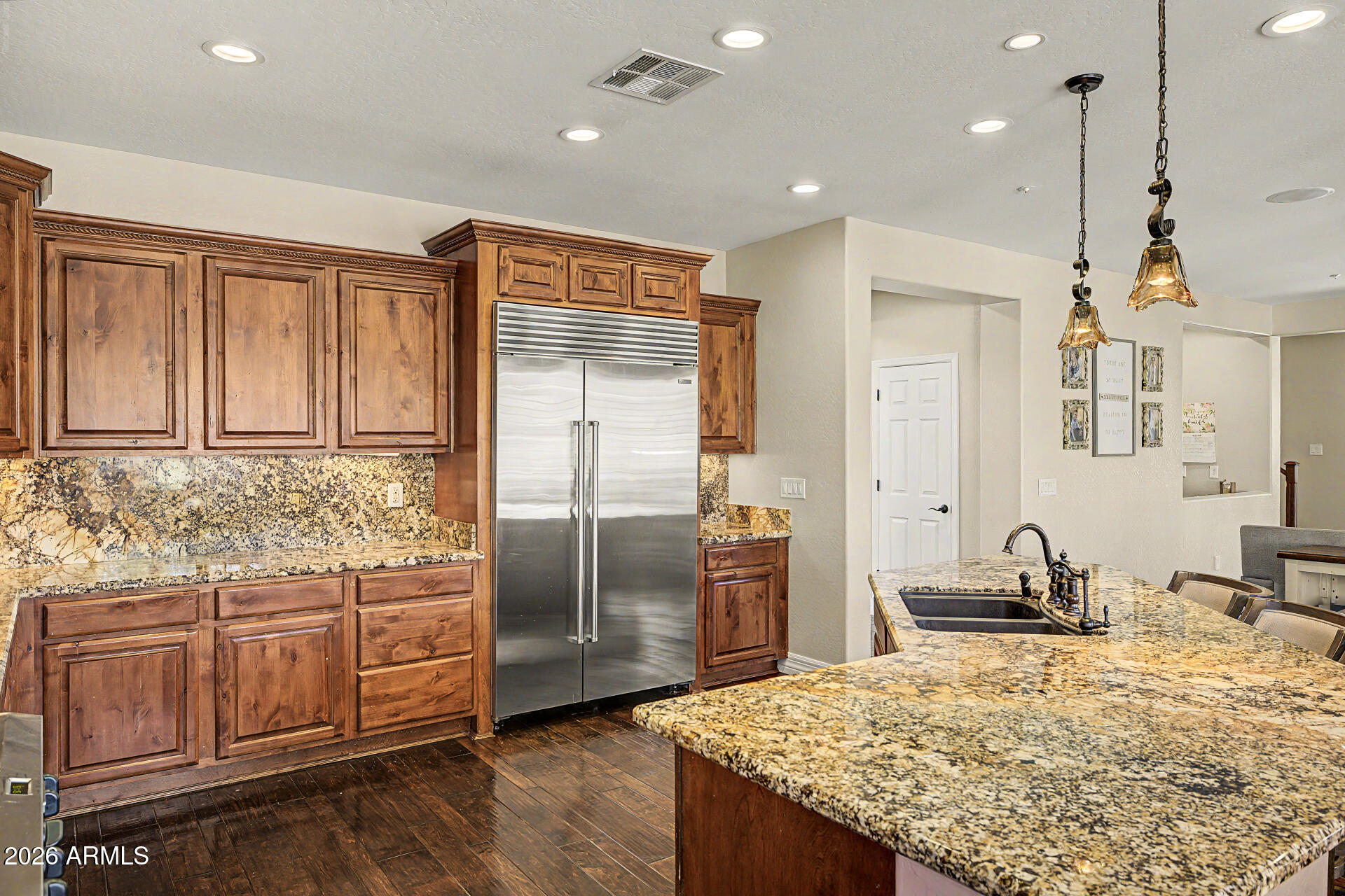 13058 West Lowden Road Peoria, AZ 85383 - Photo 33 of 122 a kitchen with stainless steel appliances granite countertop a sink refrigerator and cabinets
