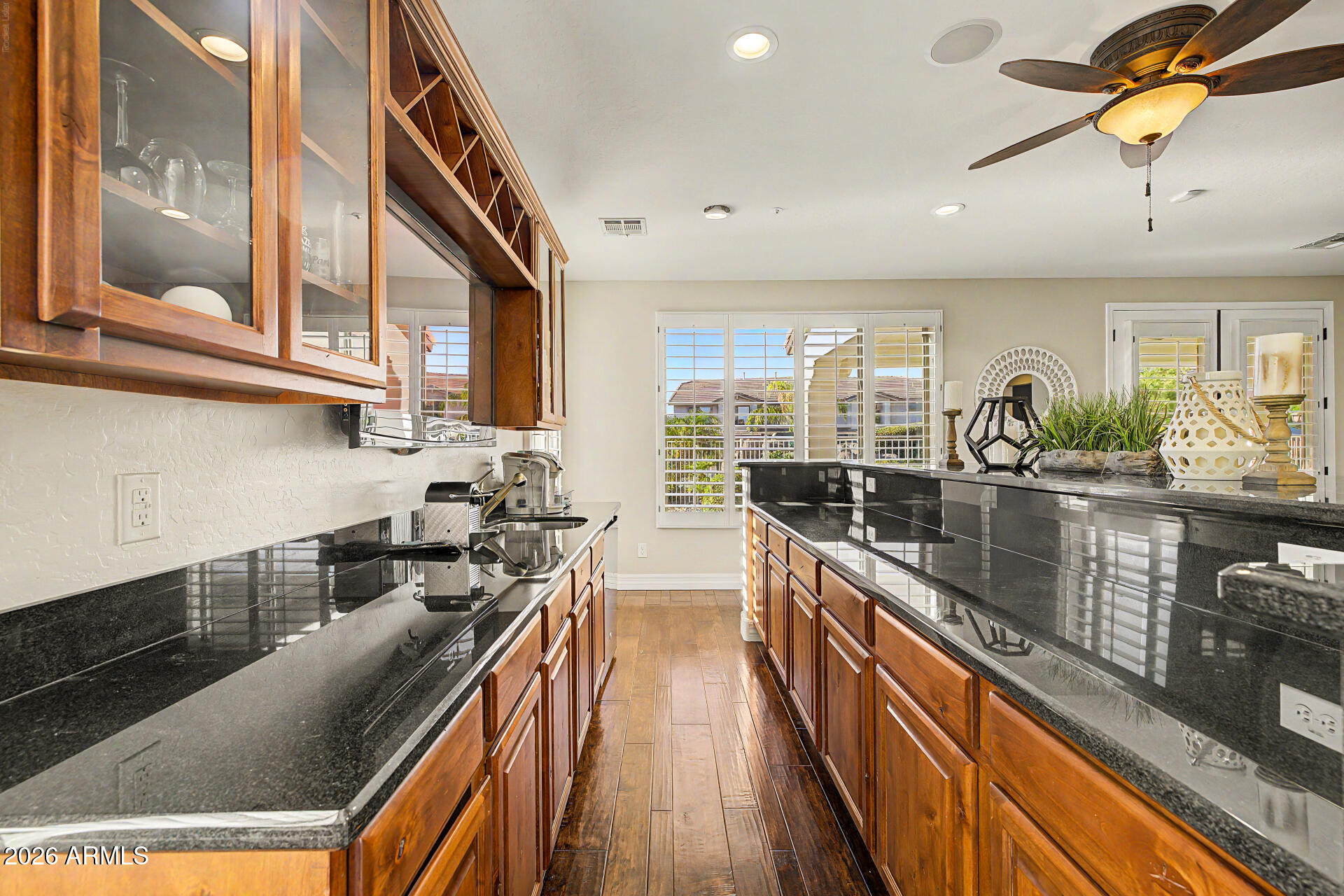 13058 West Lowden Road Peoria, AZ 85383 - Photo 45 of 122 a kitchen with stainless steel appliances granite countertop lots of counter top space and wooden floor