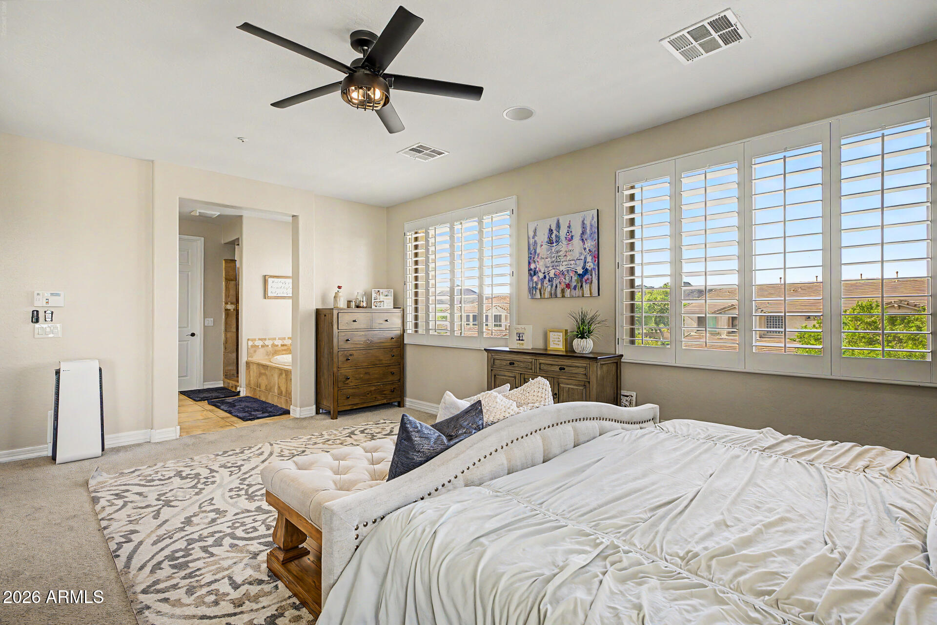 13058 West Lowden Road Peoria, AZ 85383 - Photo 52 of 122 a bedroom with a bed dresser and a large window