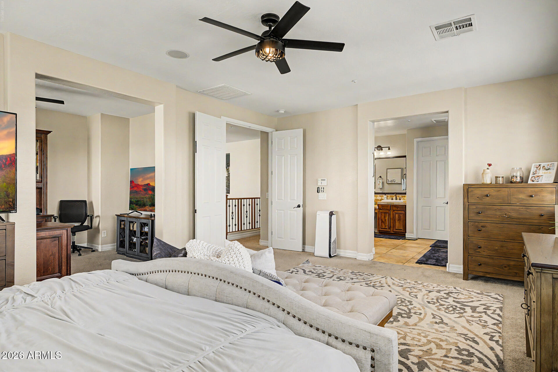 13058 West Lowden Road Peoria, AZ 85383 - Photo 53 of 122 a bedroom with a bed and a flat tv screen