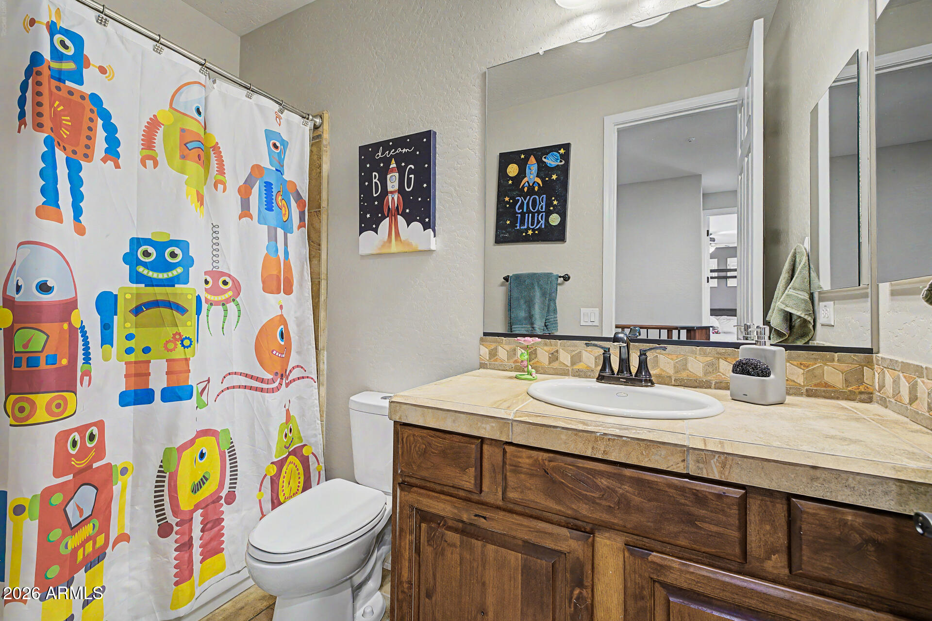 13058 West Lowden Road Peoria, AZ 85383 - Photo 61 of 122 a bathroom with a sink mirror vanity and toilet