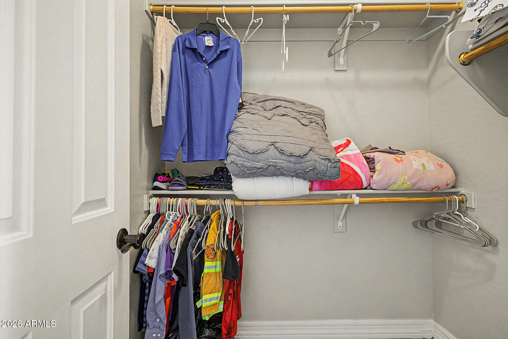 13058 West Lowden Road Peoria, AZ 85383 - Photo 62 of 122 a view of walk in closet with clothes and shoes