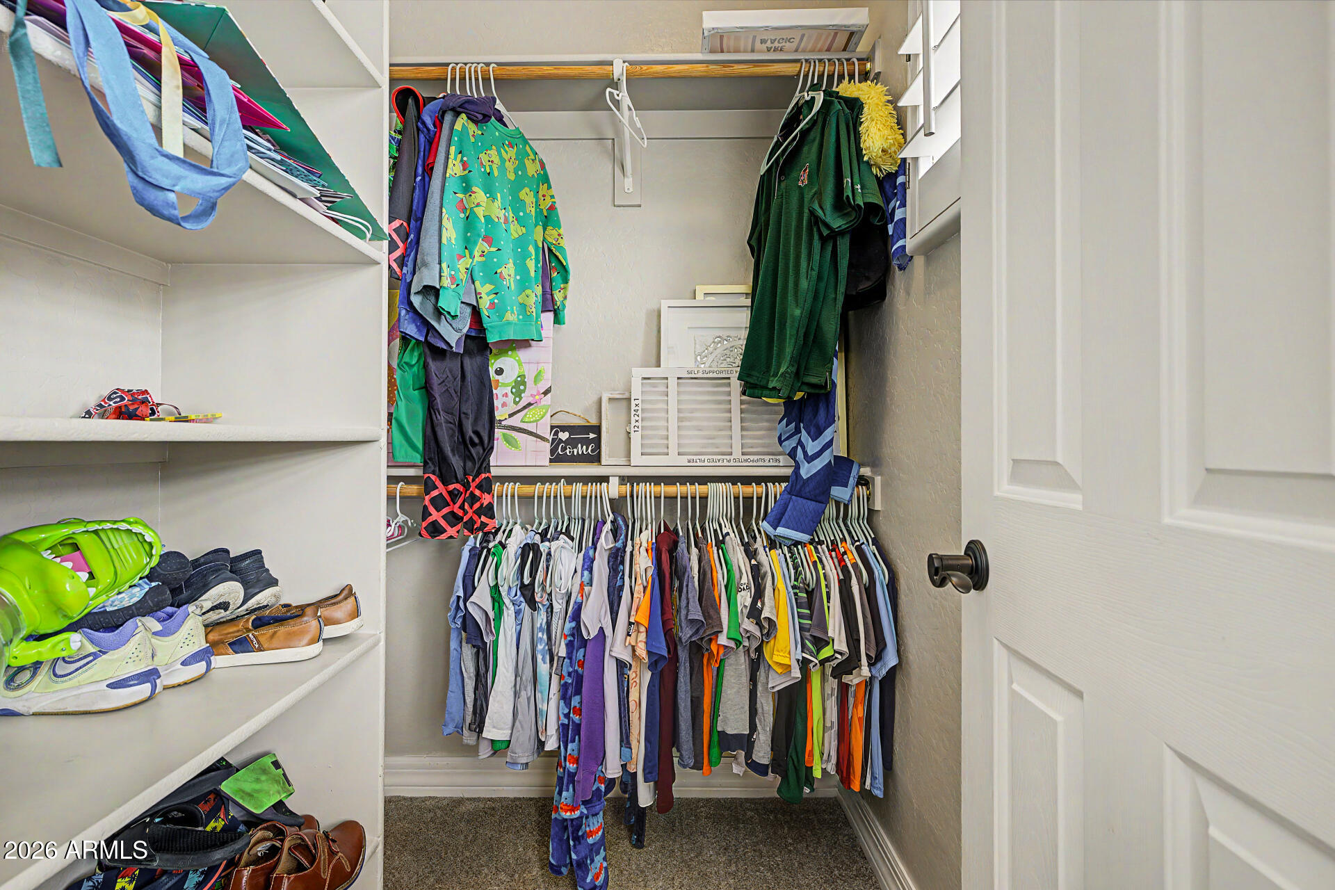 13058 West Lowden Road Peoria, AZ 85383 - Photo 66 of 122 a view of walk in closet with clothes and shoes