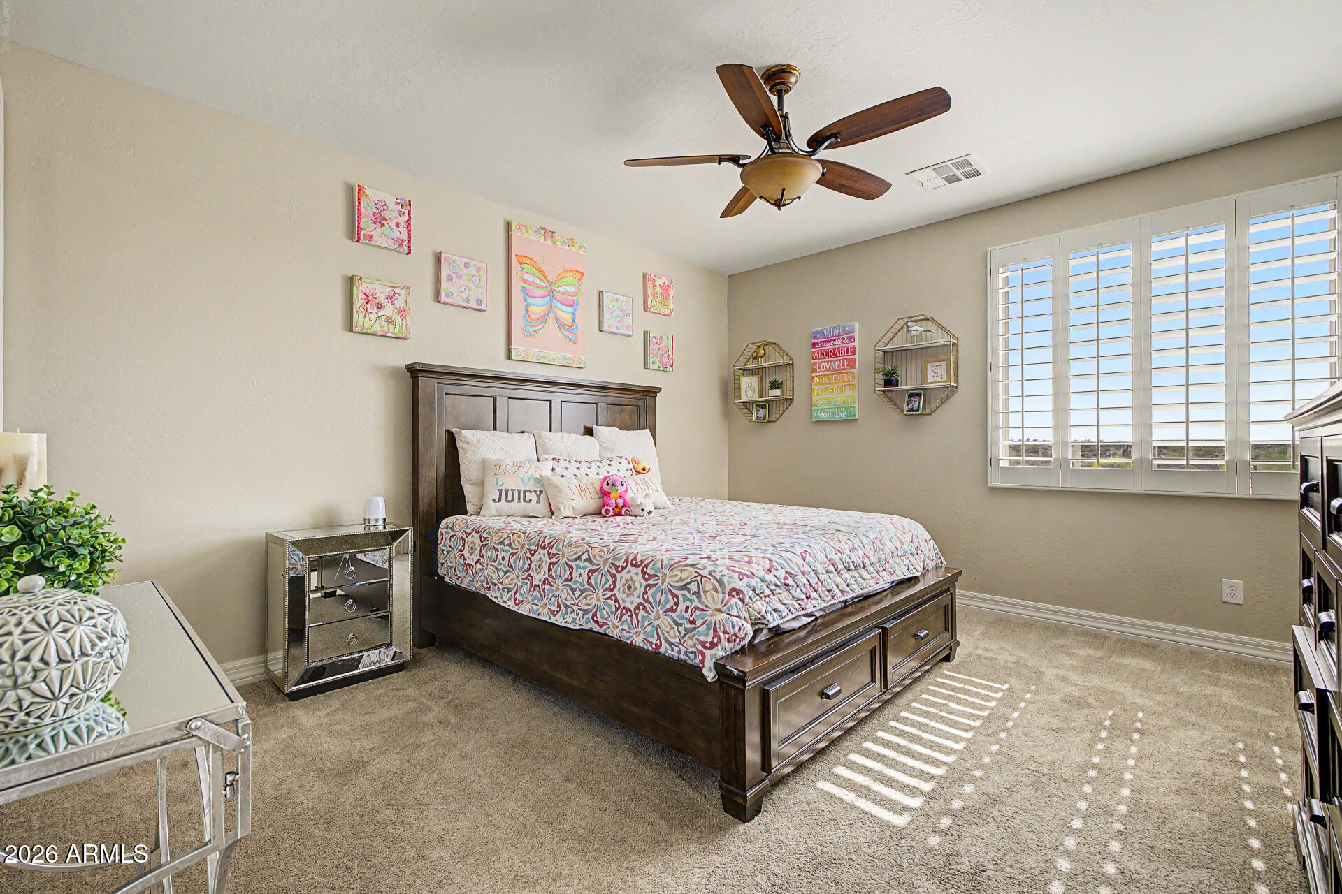 13058 West Lowden Road Peoria, AZ 85383 - Photo 67 of 122 a bedroom with a bed and a ceiling fan