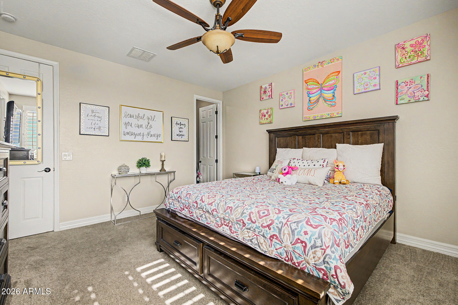 13058 West Lowden Road Peoria, AZ 85383 - Photo 69 of 122 a bedroom with a bed and a chandelier