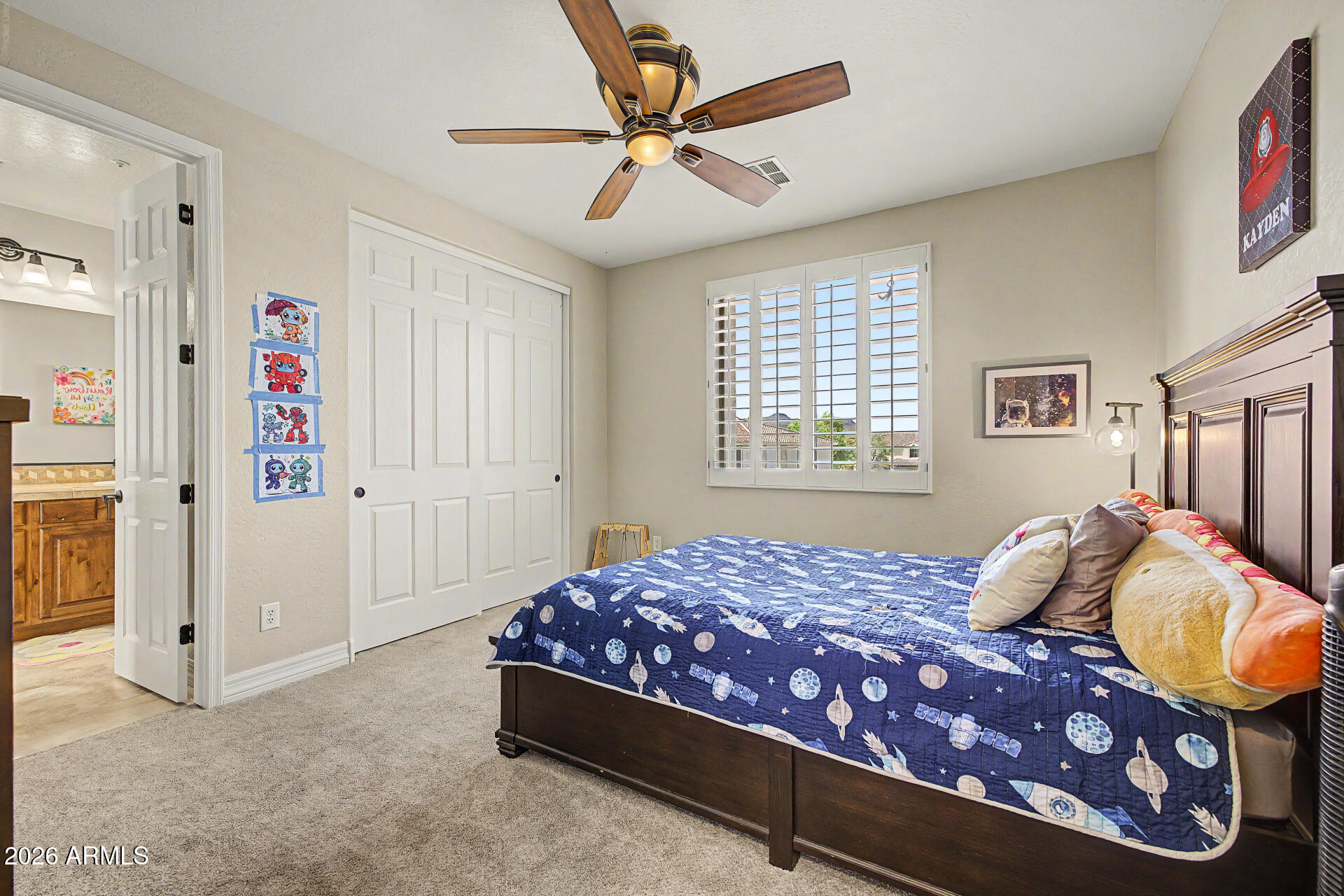 13058 West Lowden Road Peoria, AZ 85383 - Photo 72 of 122 a bedroom with a bed and a chandelier