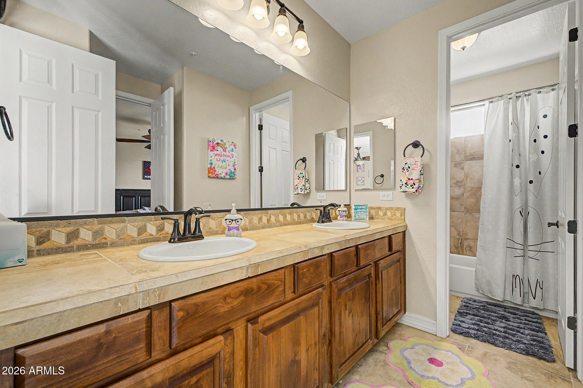 13058 West Lowden Road Peoria, AZ 85383 - Photo 73 of 122 a bathroom with a sink a vanity and a mirror