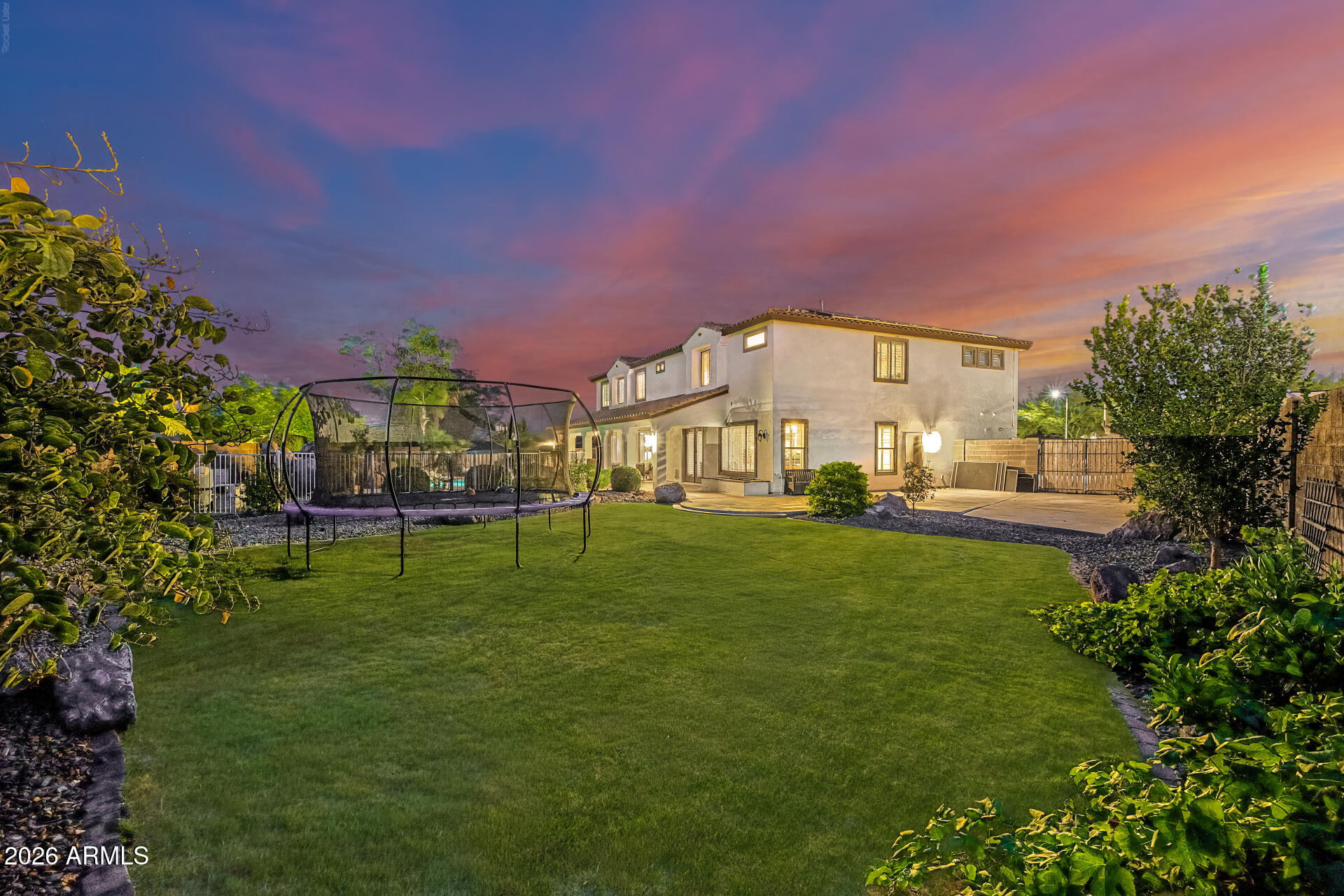 13058 West Lowden Road Peoria, AZ 85383 - Photo 83 of 122 a view of a big house with a big yard and large trees