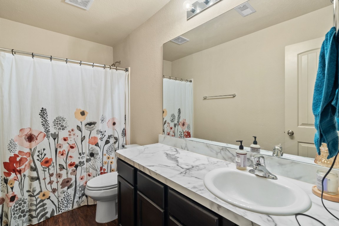 2034 Harmon Park Court Spring, TX 77373 - Photo 22 of 31 a bathroom with a granite countertop sink and a mirror