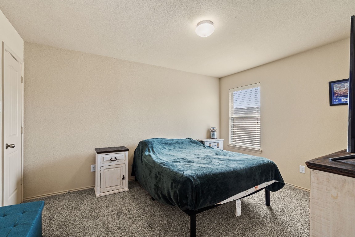 2034 Harmon Park Court Spring, TX 77373 - Photo 23 of 31 a bedroom with a bed and a dresser