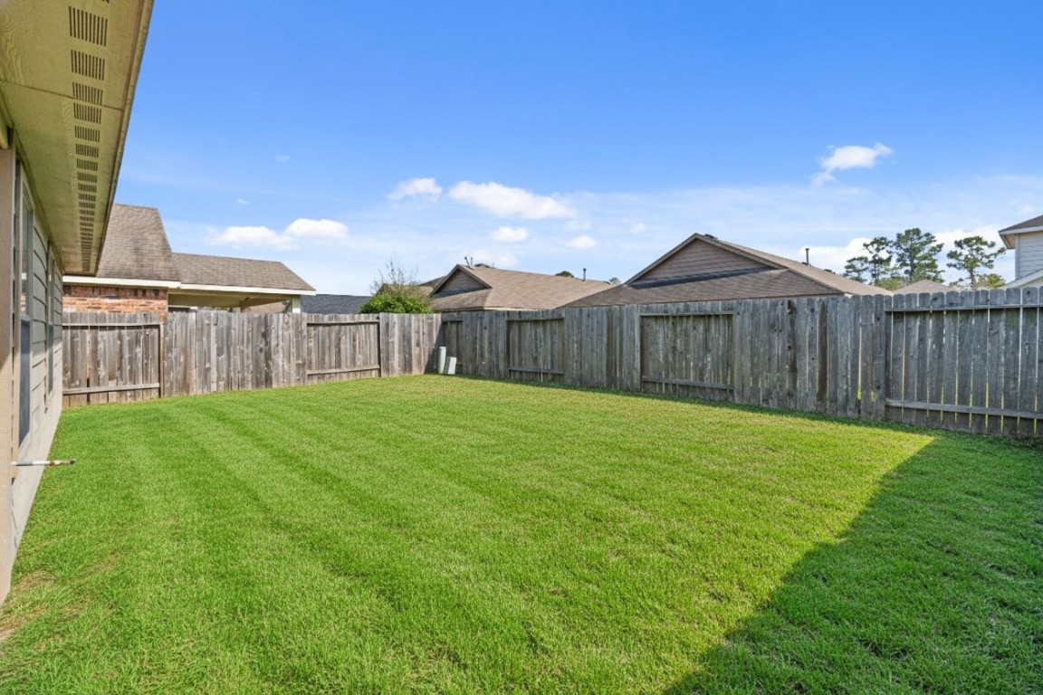 2034 Harmon Park Court Spring, TX 77373 - Photo 28 of 31 a view of a backyard with a garden
