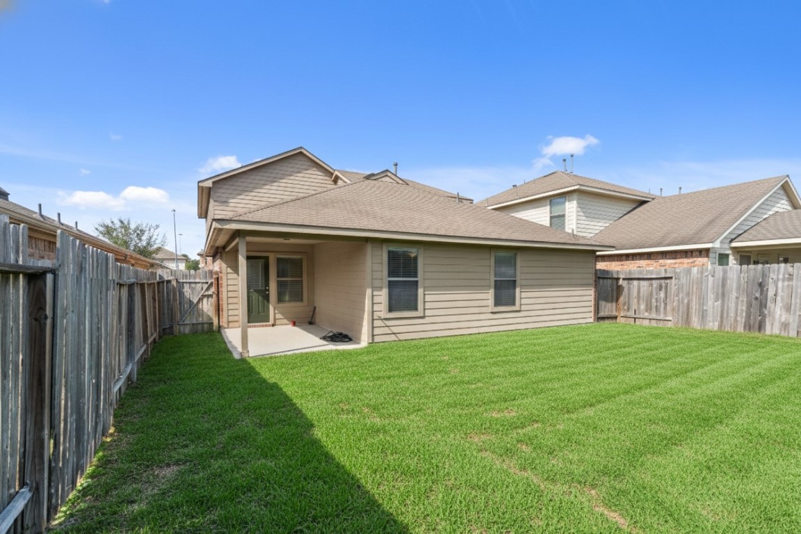 2034 Harmon Park Court Spring, TX 77373 - Photo 29 of 31 a front view of a house with yard and green space