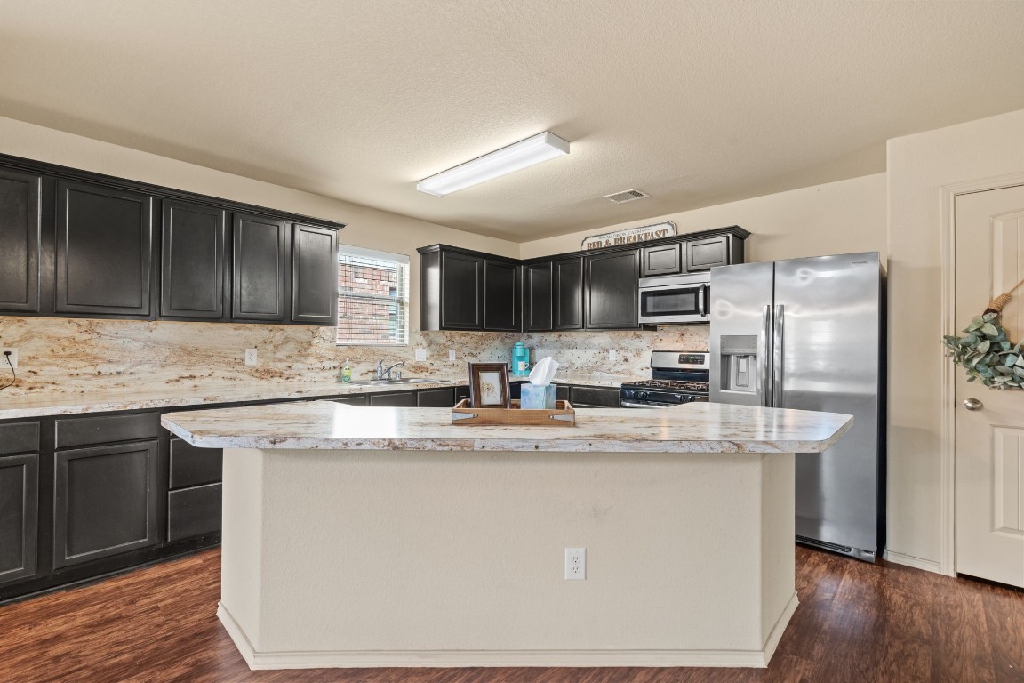 2034 Harmon Park Court Spring, TX 77373 - Photo 6 of 31 a kitchen with stainless steel appliances granite countertop a sink stove and refrigerator
