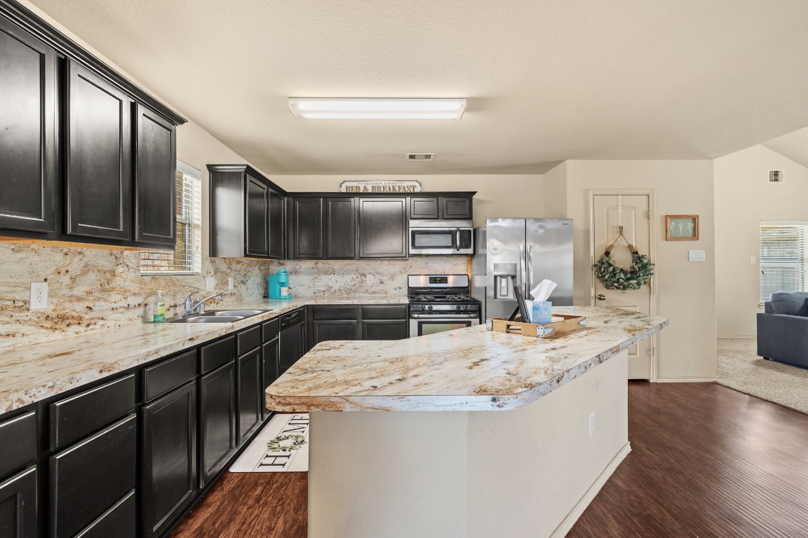2034 Harmon Park Court Spring, TX 77373 - Photo 7 of 31 a kitchen with stainless steel appliances granite countertop a sink stove and refrigerator