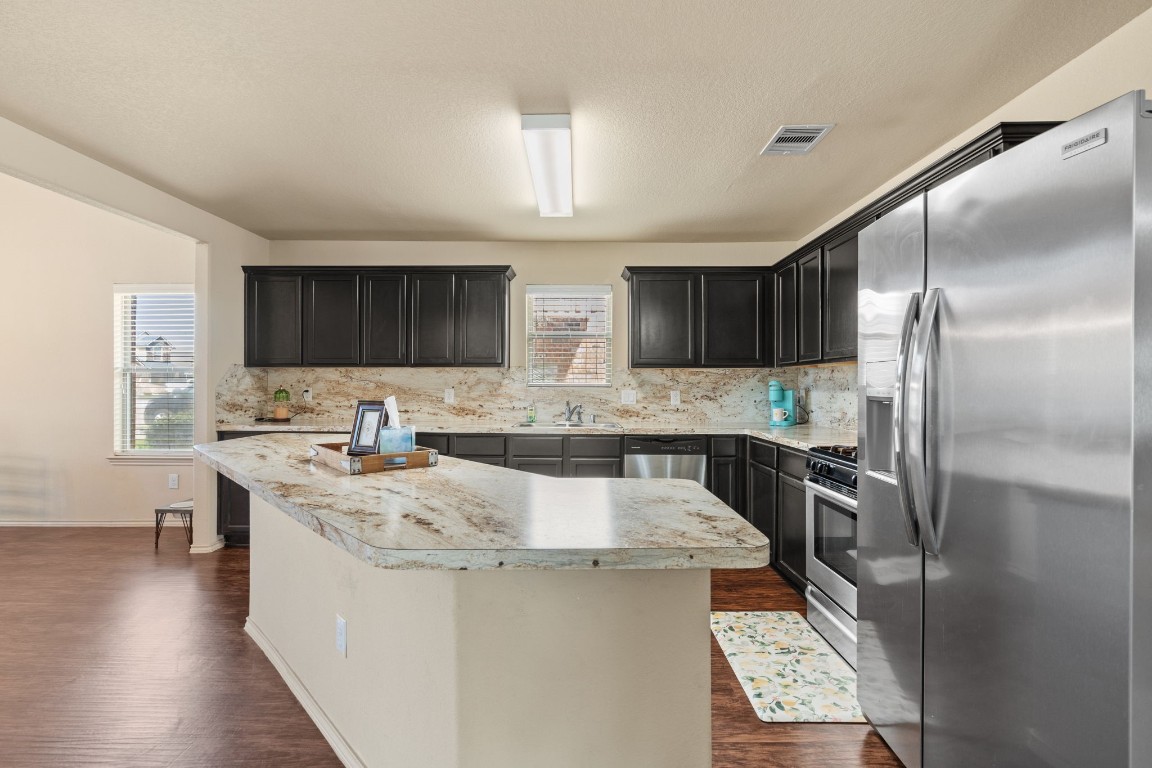 2034 Harmon Park Court Spring, TX 77373 - Photo 8 of 31 a kitchen with stainless steel appliances granite countertop a sink stove and refrigerator