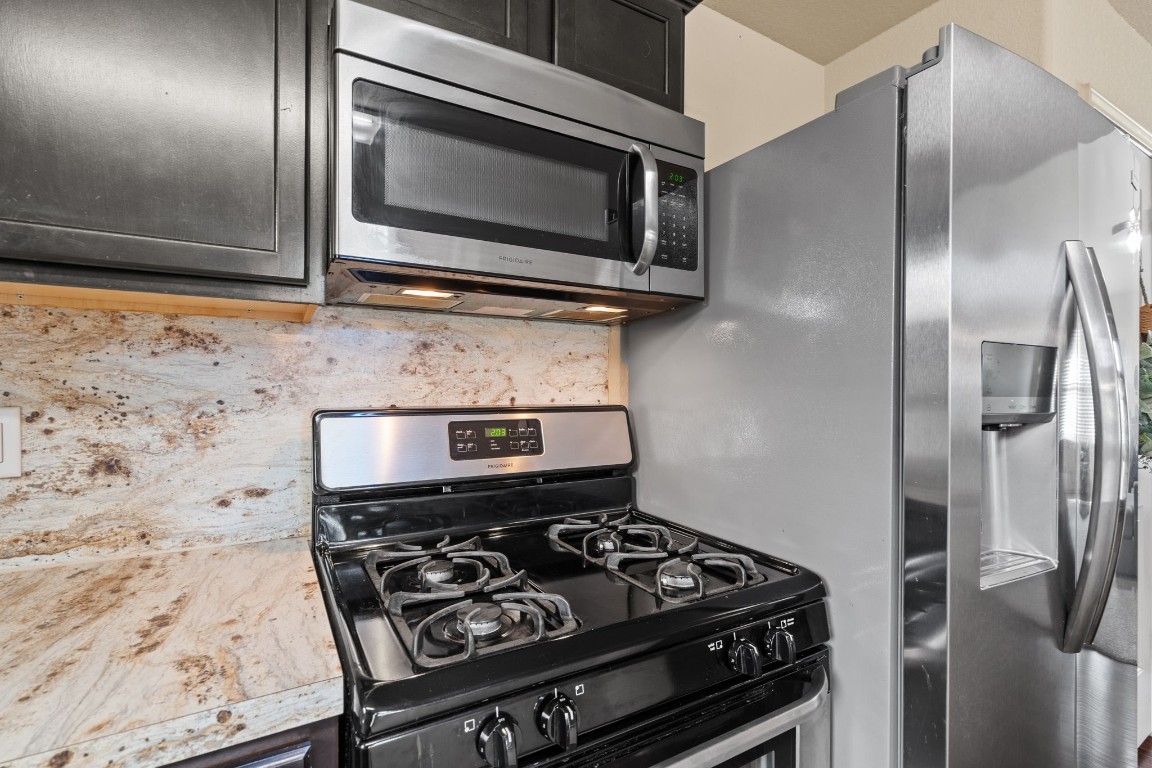 2034 Harmon Park Court Spring, TX 77373 - Photo 9 of 31 a kitchen with a stove and a microwave