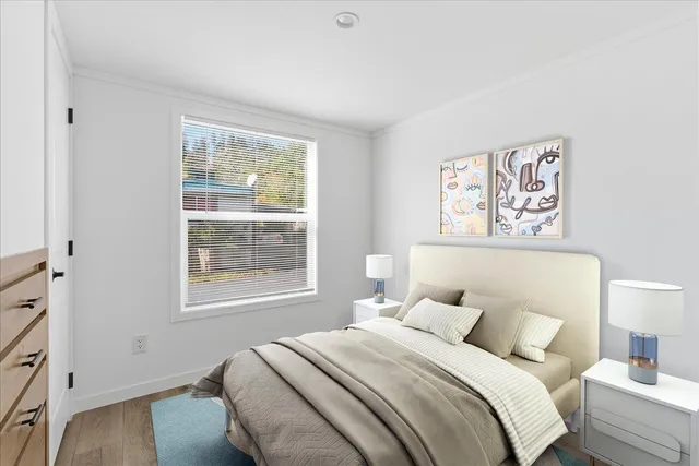 a bedroom with bed and a window