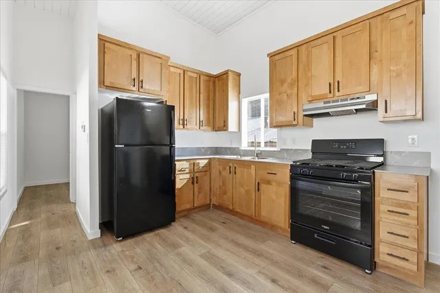 a kitchen with a refrigerator stove and cabinets