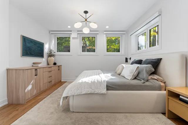 a living room with furniture a flat screen tv and a window