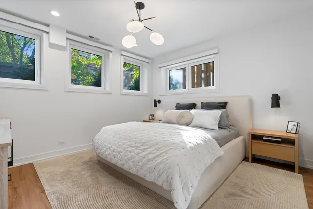 a spacious bedroom with a bed and a window