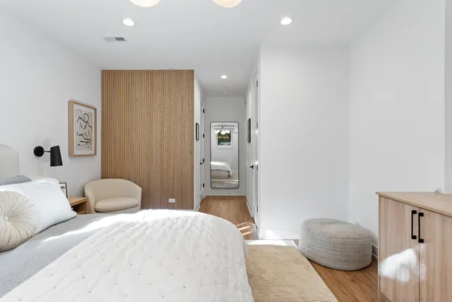 a bedroom with a bed and lamp