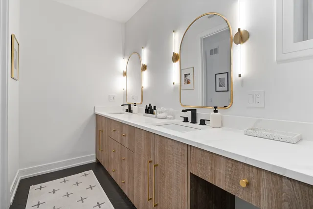 a bathroom with a double vanity sink and a mirror