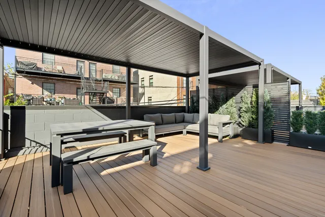 a view of a patio with table and chairs with wooden floor and floor to ceiling window