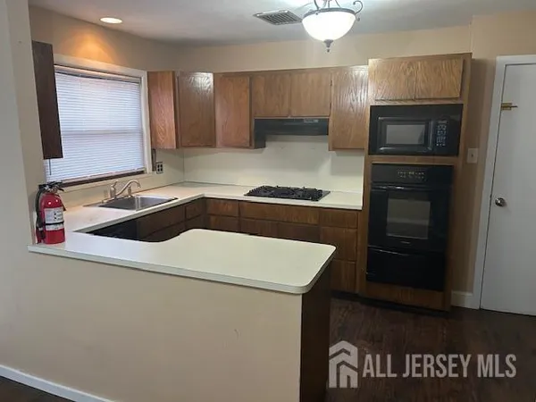 a kitchen that has a sink and a stove in it