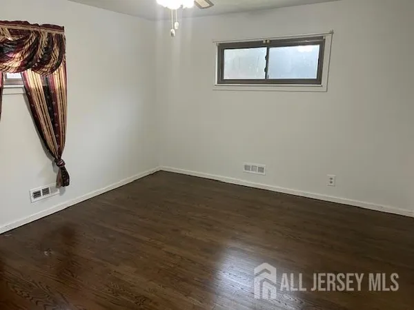 a view of a room with wooden floor and stairs