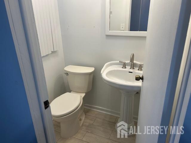3 Brookside Road Edison, NJ 08817 - Photo 9 of 16 a white toilet sitting next to a sink and vanity